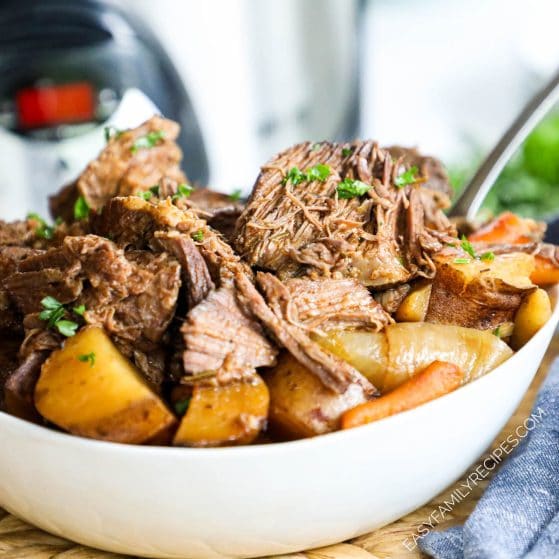 Classic beef pot roast with potatoes and carrots cooked in a slow cooker
