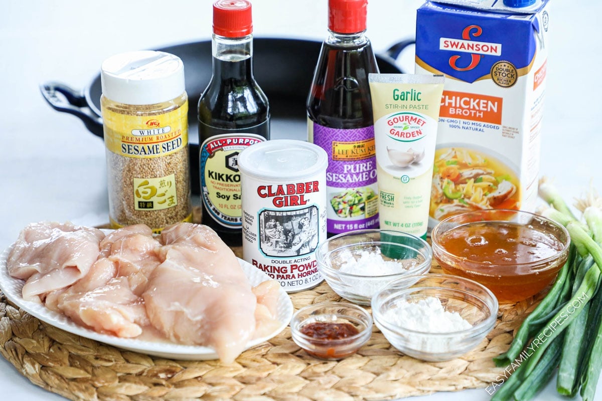 Ingredients to make honey sesame chicken including chicken breasts, soy sauce, sesame oil, garlic, sesame seeds, and cornstarch