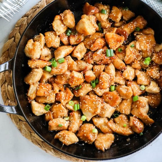 A pan of cooked sesame honey chicken