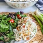 Chicken salad on a plate with a green salad next to it
