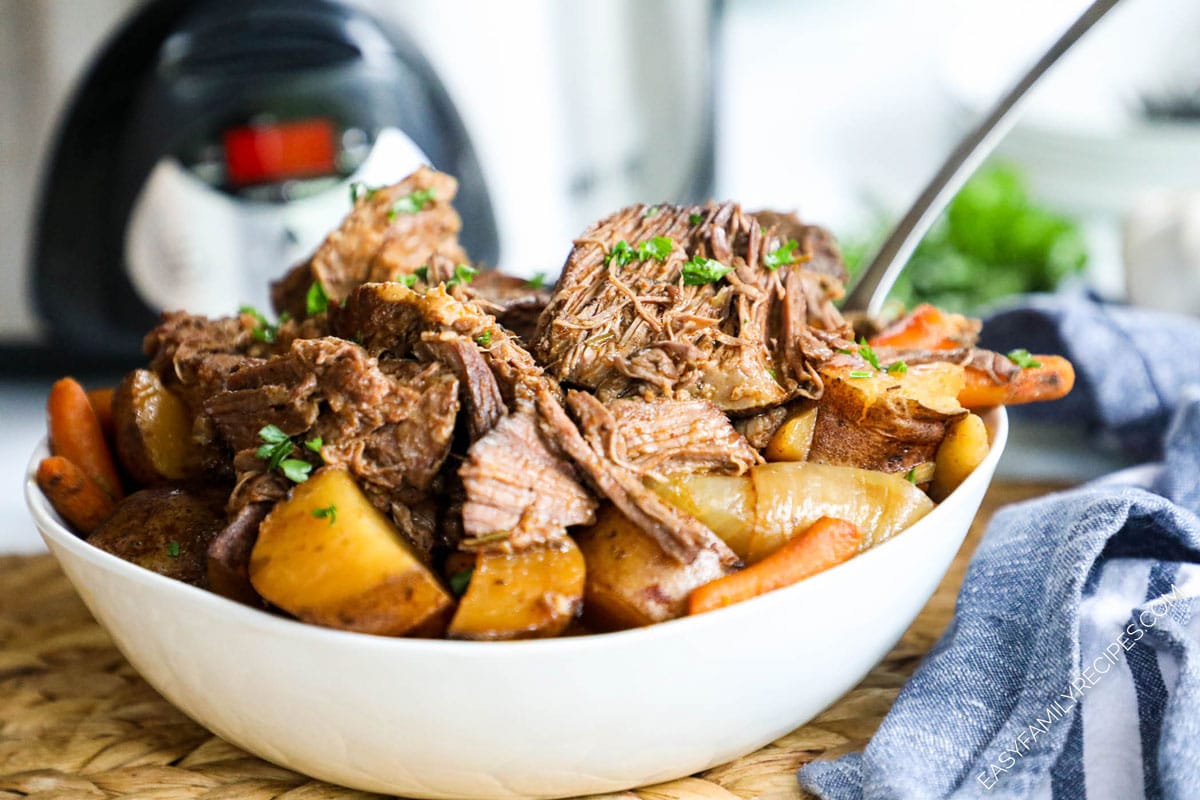 pot roast with potatoes and carrots in serving bowl
