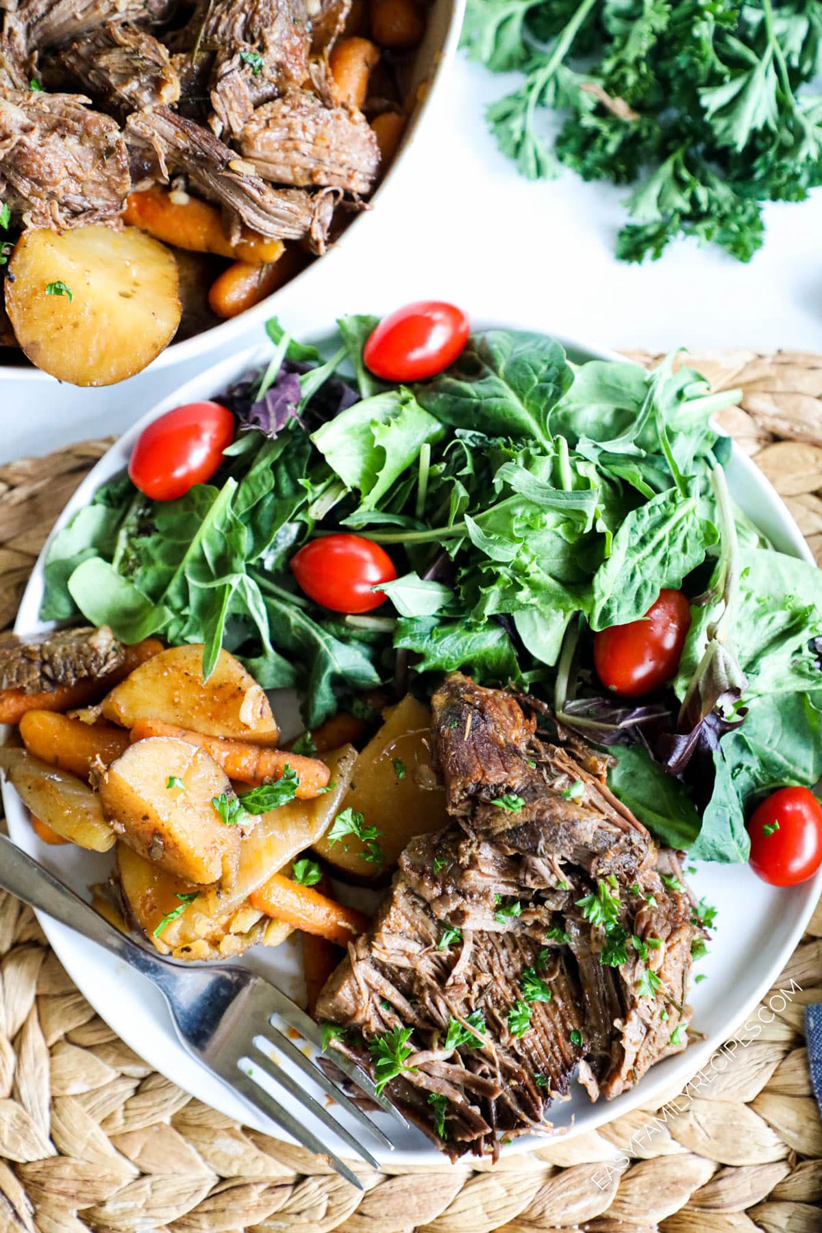 Pot roast with potatoes and carrots served with salad