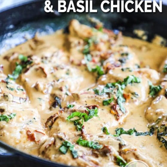 close up of the chicken in a cream sauce with fresh basil in a skillet.