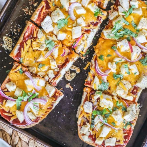 BBQ Chicken French Bread Pizza cut up on a baking sheet.