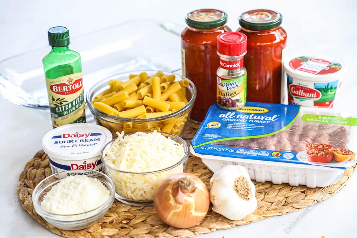 ingredients to make baked ziti with ground turkey including marinara, mozzarella, Parmesan, ricotta, and sour cream