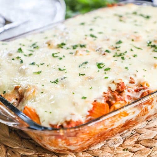 a casserole dish with baked ziti, cheese, and ground turkey