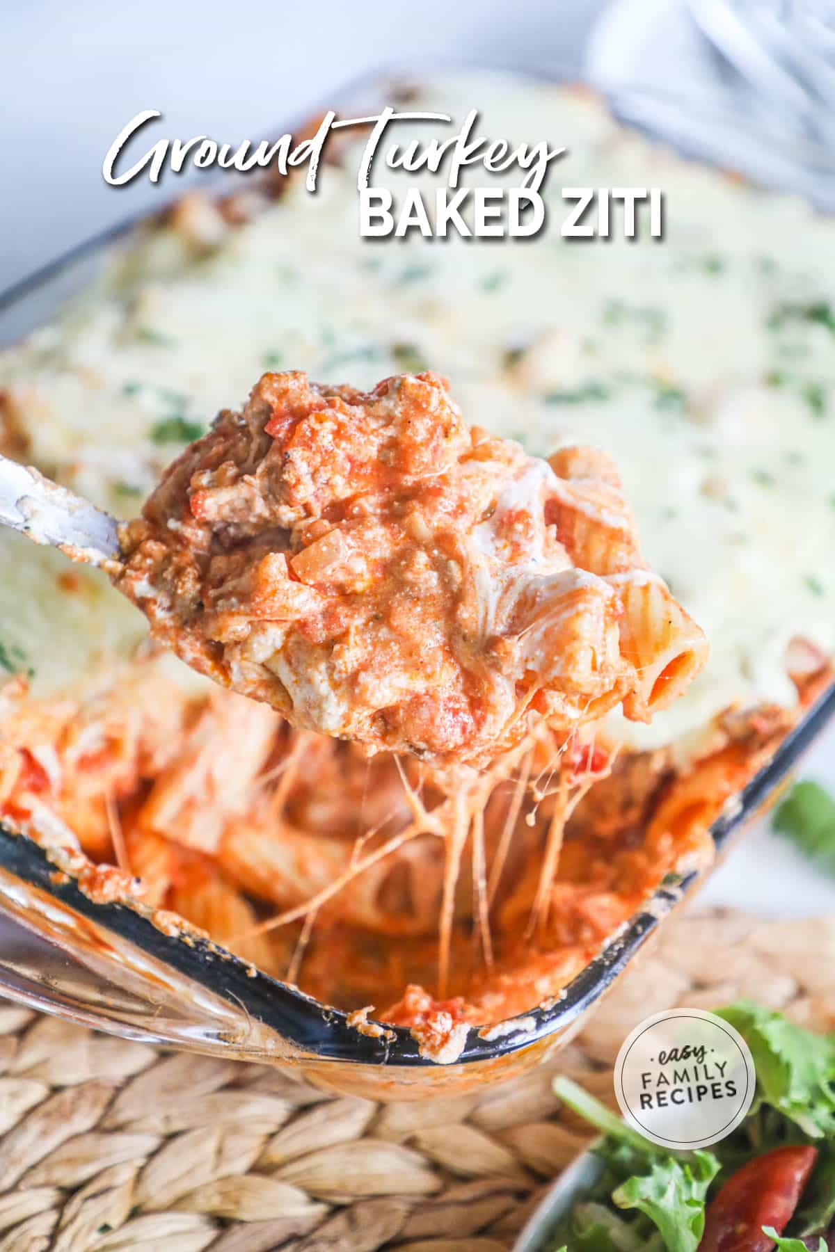 A scoop of baked ziti with cheese, ground turkey, and marinara