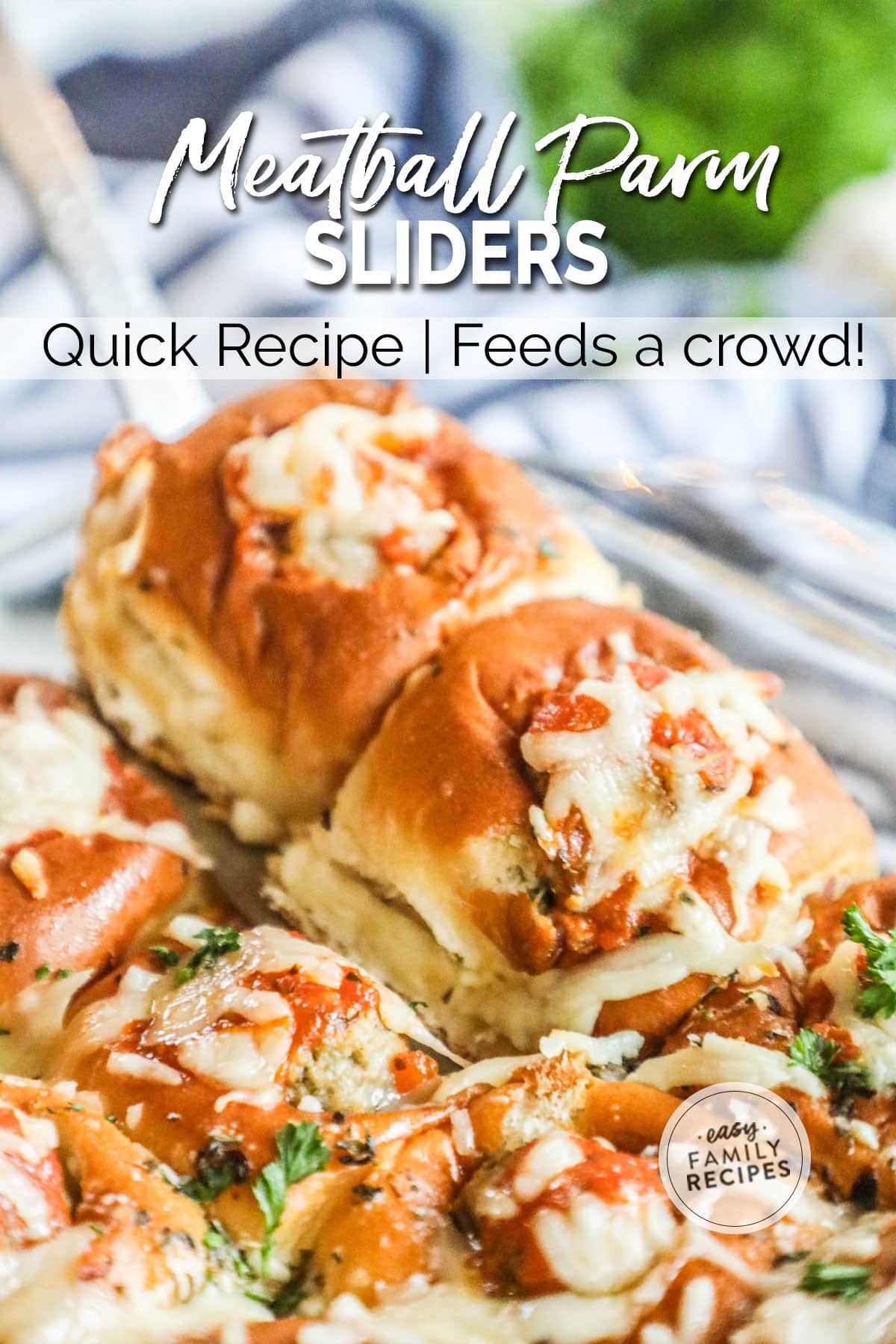 Meatball parmesan sliders being lifted out of a tray.