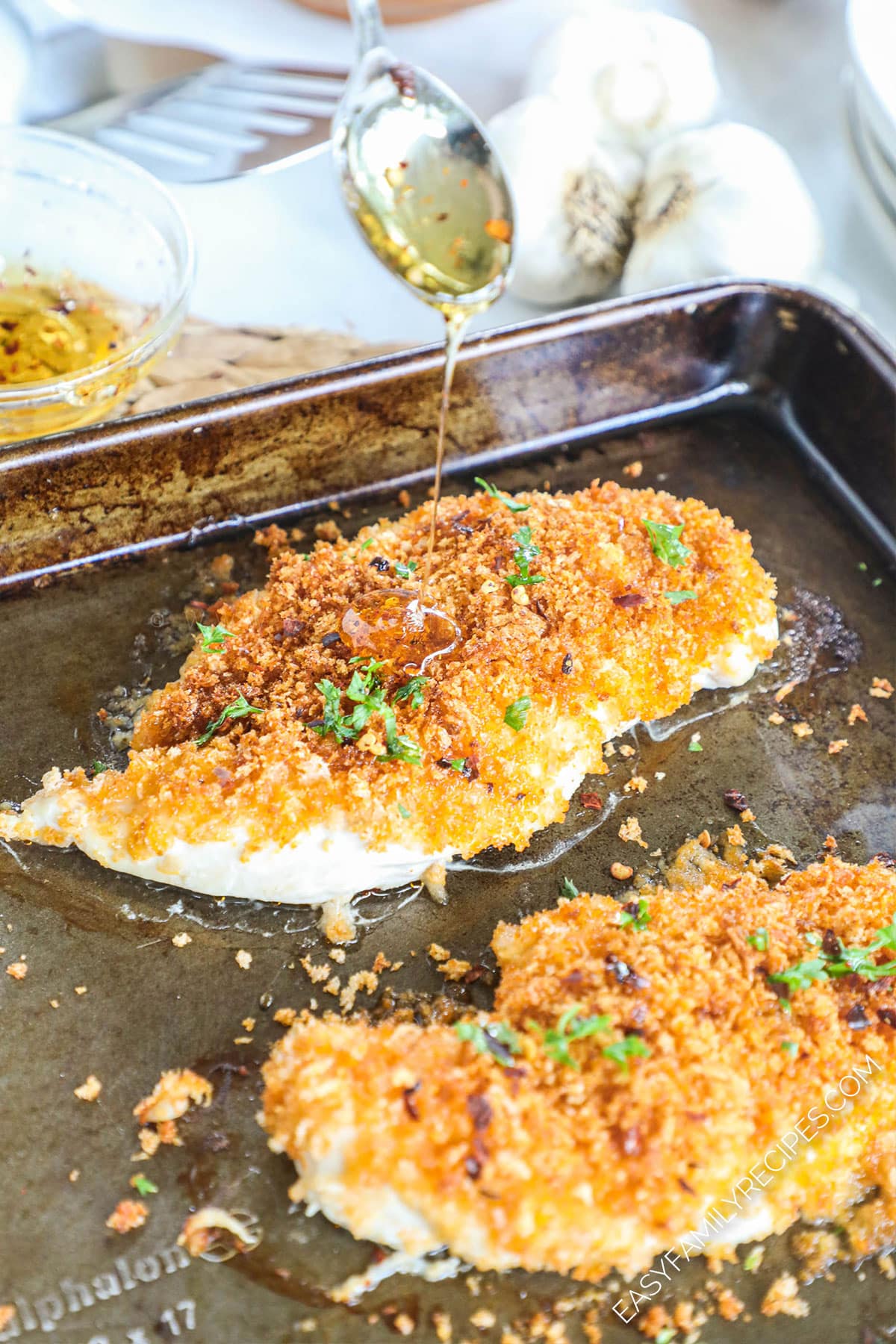 Chicken breast being drizzled with honey glaze.