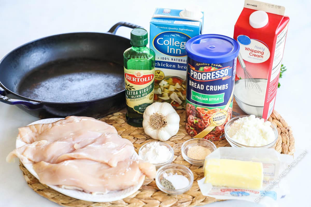 Ingredients to make chicken fritta with garlic cream sauce including chicken, breadcrumbs, parmesan, garlic, and cream.