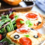 Garlic bread pizza served with salad on a plate.