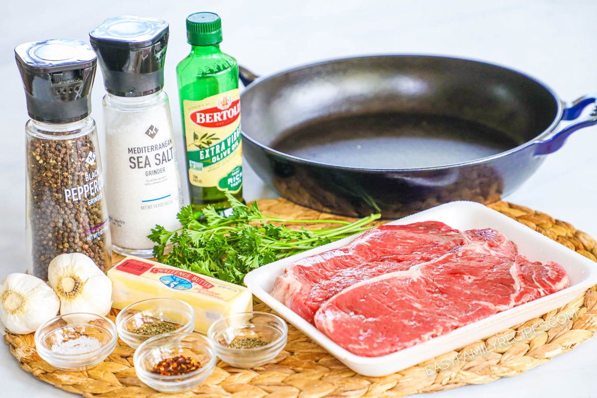 Ingredients for garlic herb steak including steak, garlic, olive oil, butter, salt, pepper, herbs, and red pepper flakes.