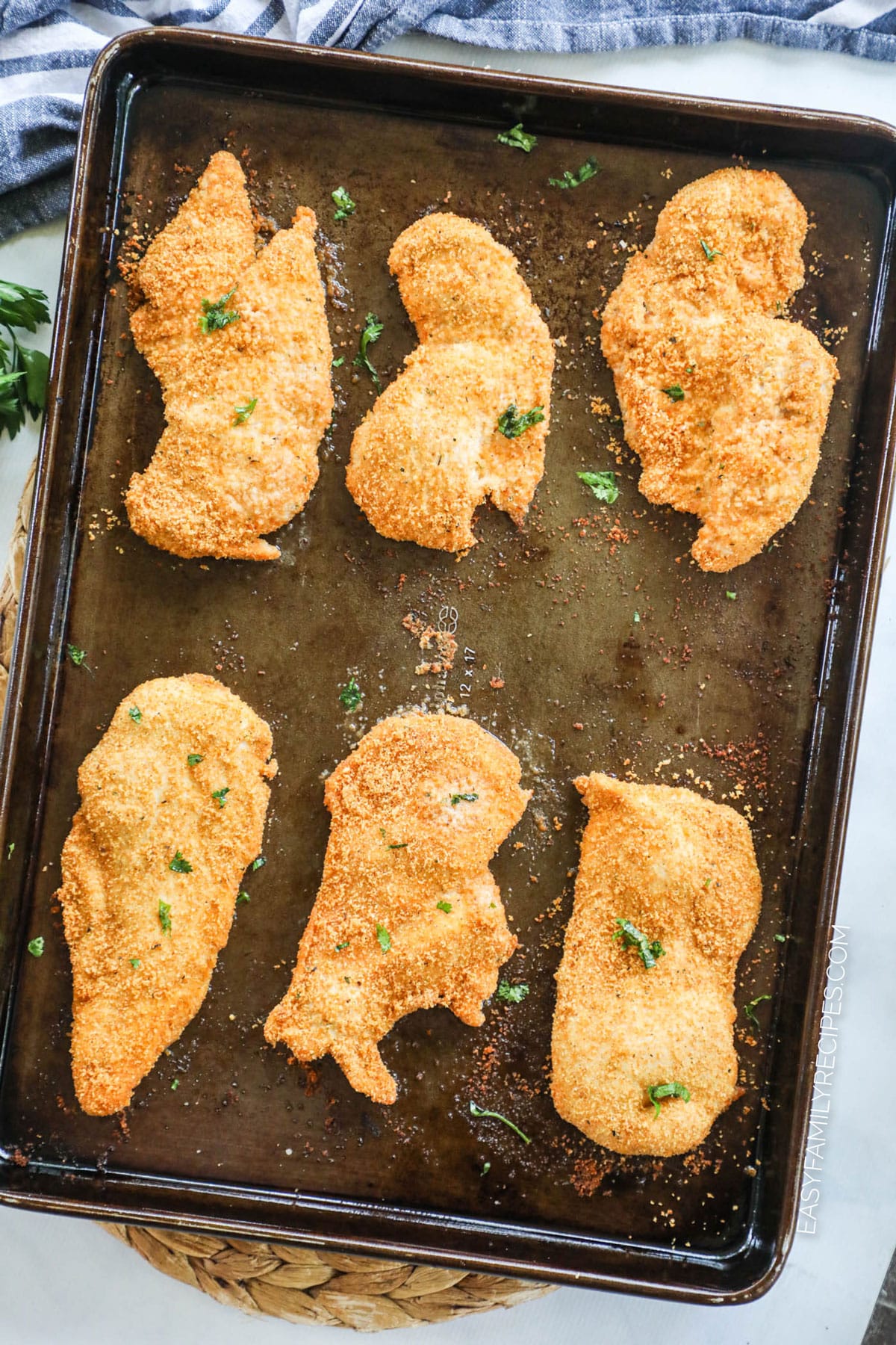Homemade Shake and Bake Chicken breast prepared on a baking sheet