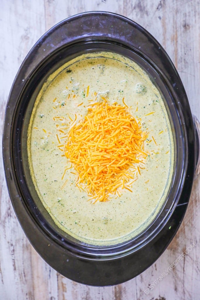 Step 3 for how to make broccoli cheese soup in crockpot- Add cream and cheddar cheese