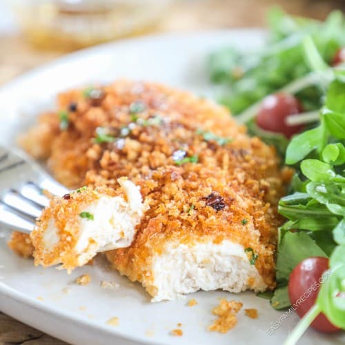 Crispy Baked Panko Chicken on a plate with a bite cut out to show the tender juicy chicken