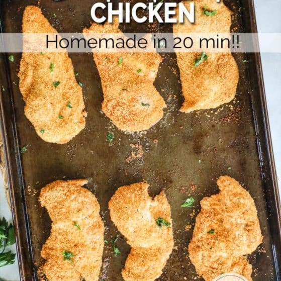 breaded chicken cutlets baked to golden brown on a cookie sheet.