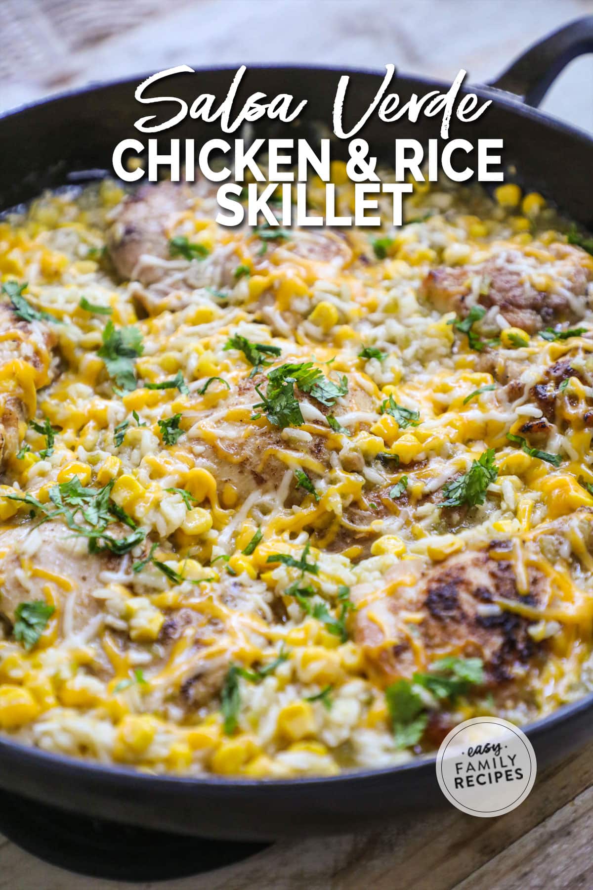 a large pan of chicken thighs with corn, rice, and cheese.