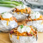 Baked potatoes stuffed with chili and toppings and wrapped in foil