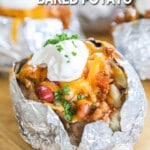 Baked potatoes stuffed with chili and toppings and wrapped in foil