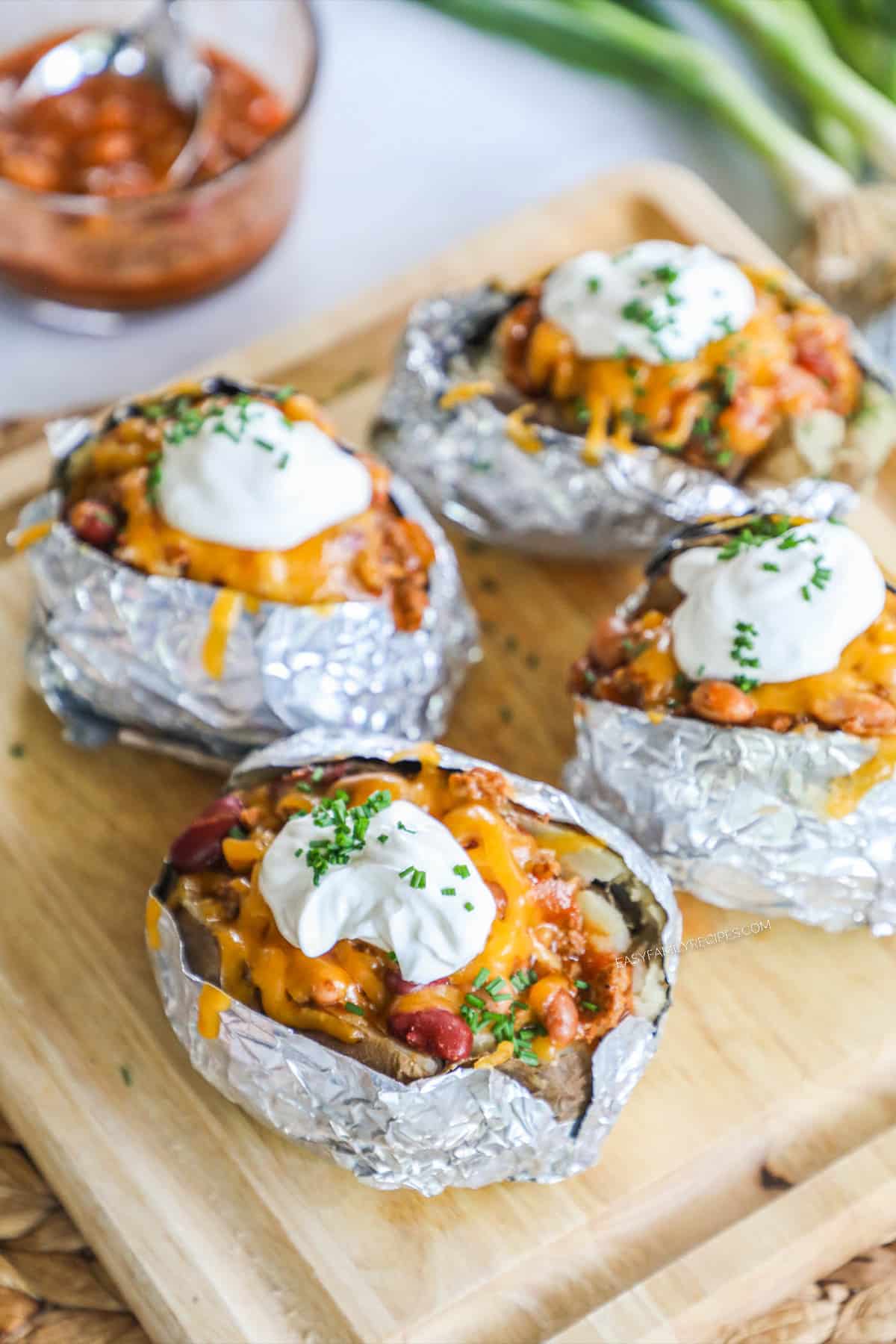 Chili stuffed baked potato wrapped in foil