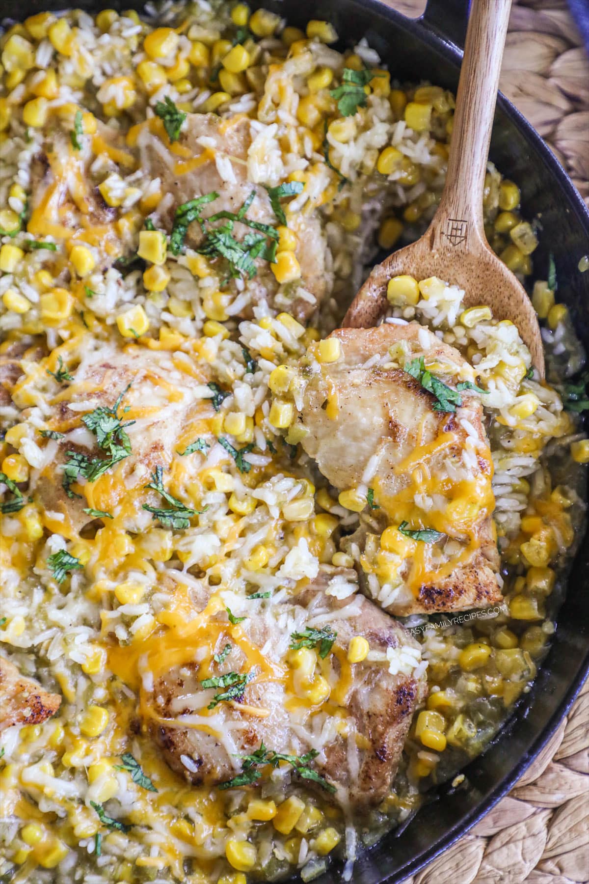 A skillet of chicken cooked with rice and salsa verde.