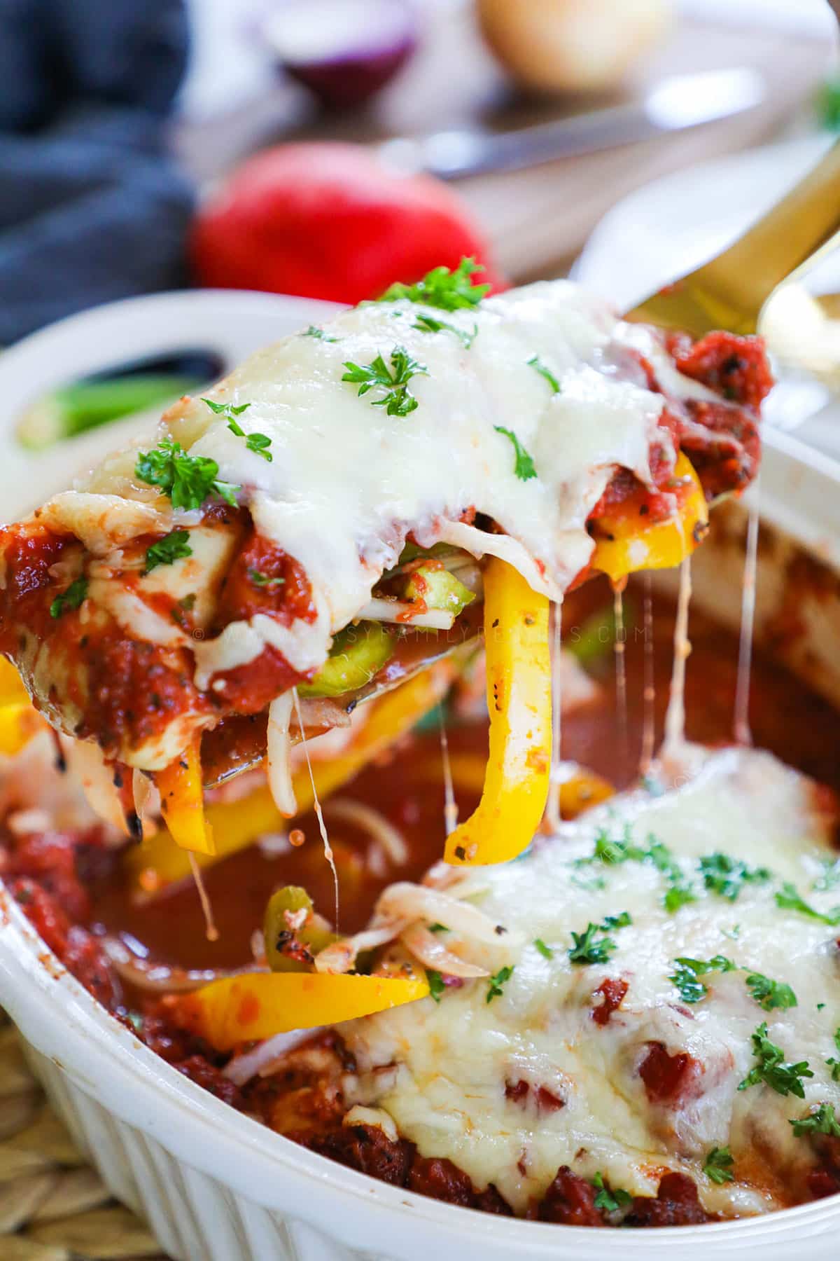 Baked Italian Chicken and Peppers being scooped out with a spoon
