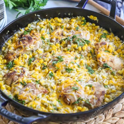 A skillet of chicken cooked with rice and salsa verde.