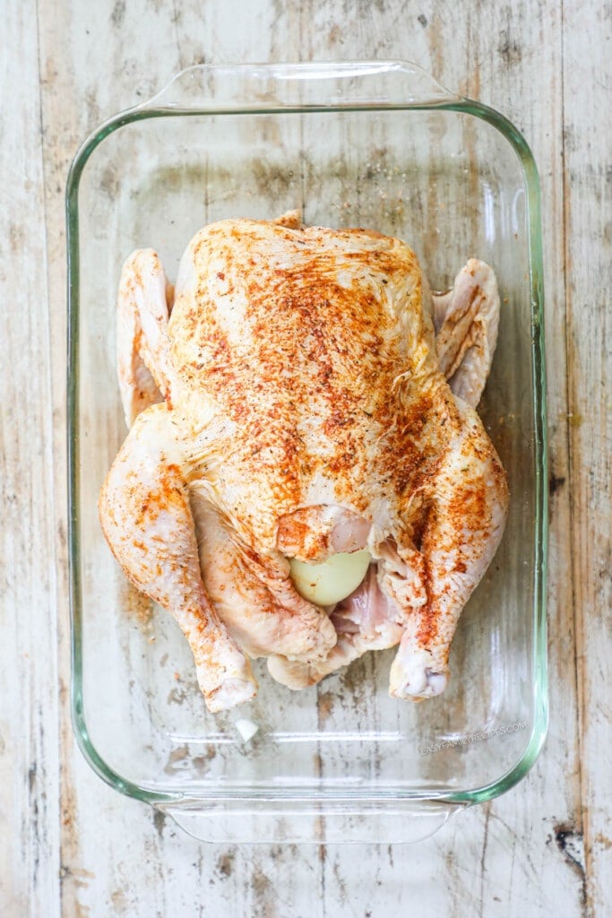 How to make rotisserie chicken in the oven step 2: Spread seasonings over skin on all sides of the whole chicken.