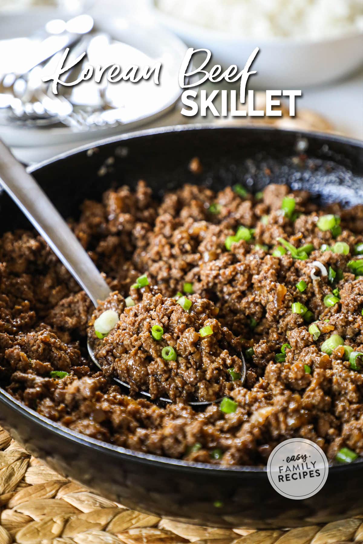 a skillet of korean ground beef topped with green onions.