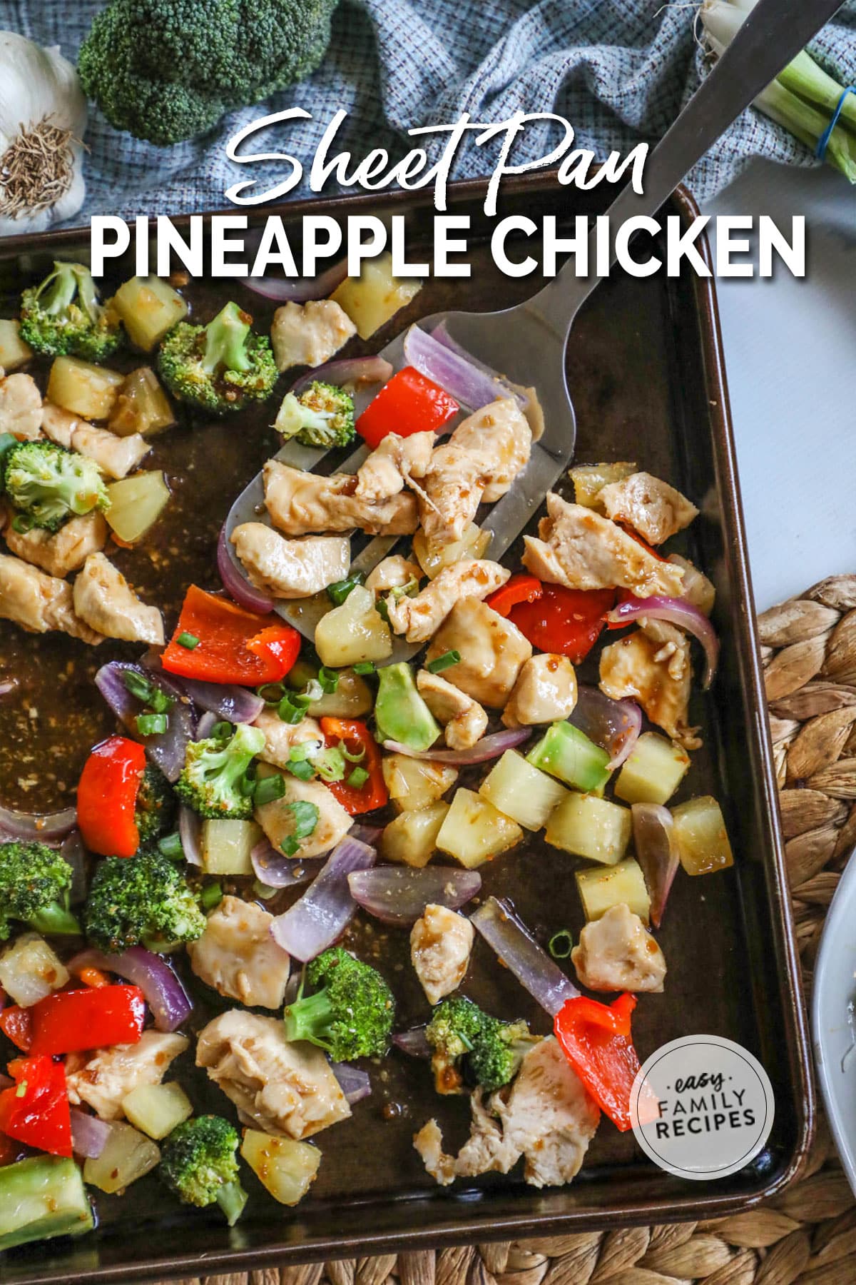 a sheet pan with veggies, chicken and pineapple in teriyaki sauce.