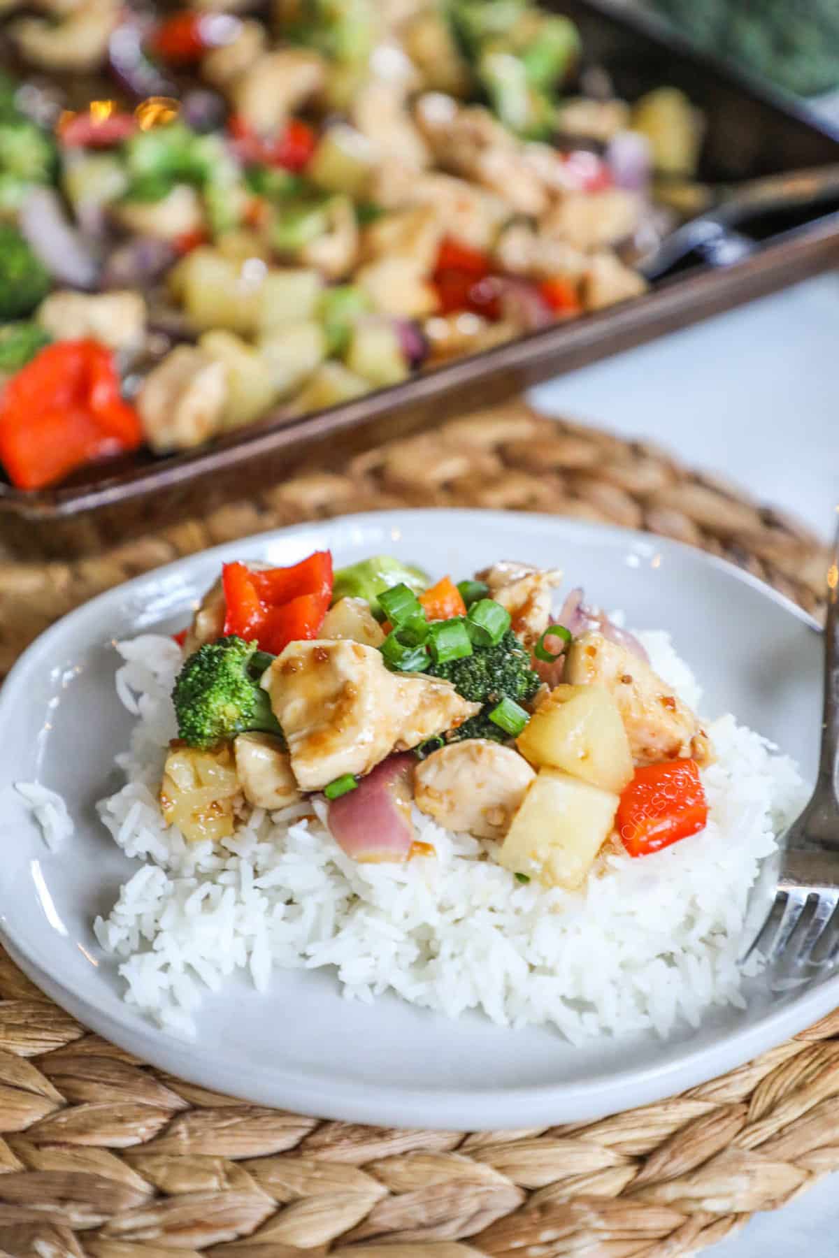 Sheet Pan Pineapple Chicken served with rice for an easy weeknight dinner.