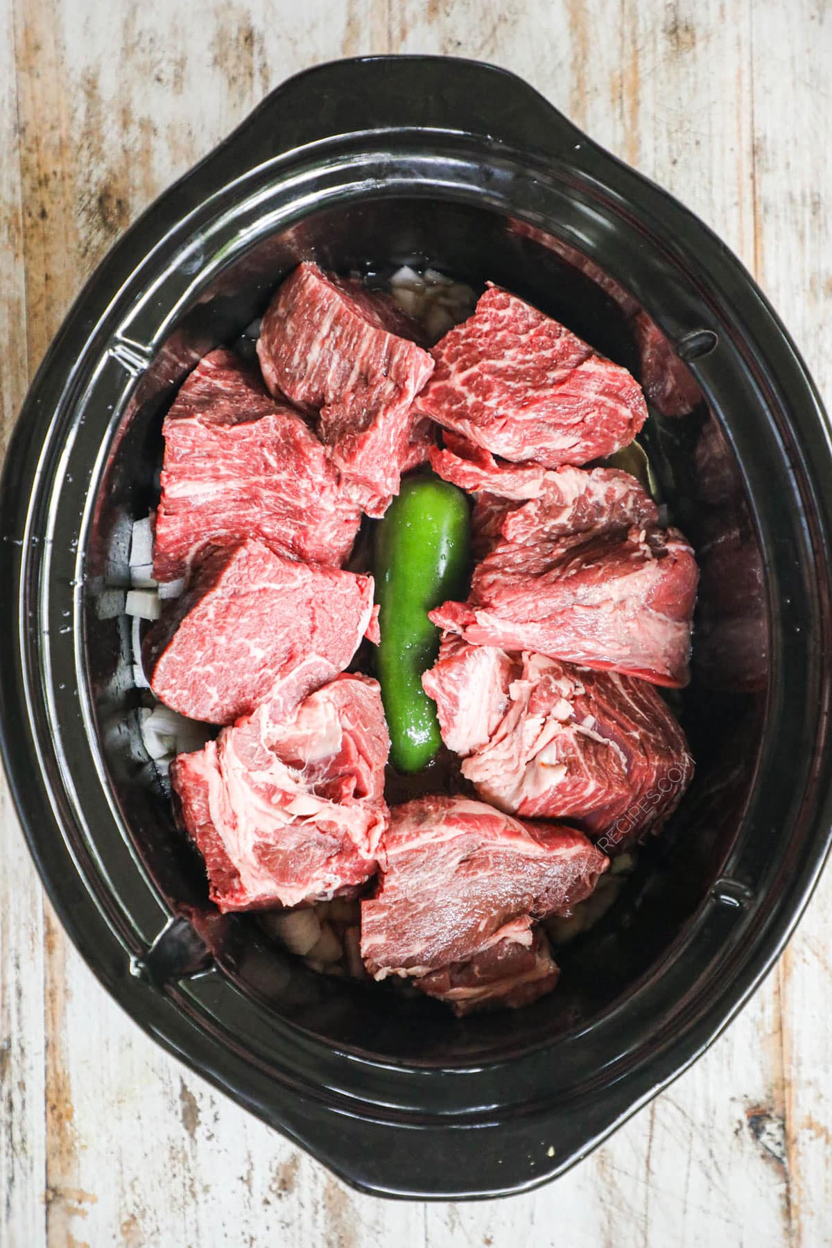 How to make Beef Barbacoa Step 2 - Add sliced beef to slow cooker