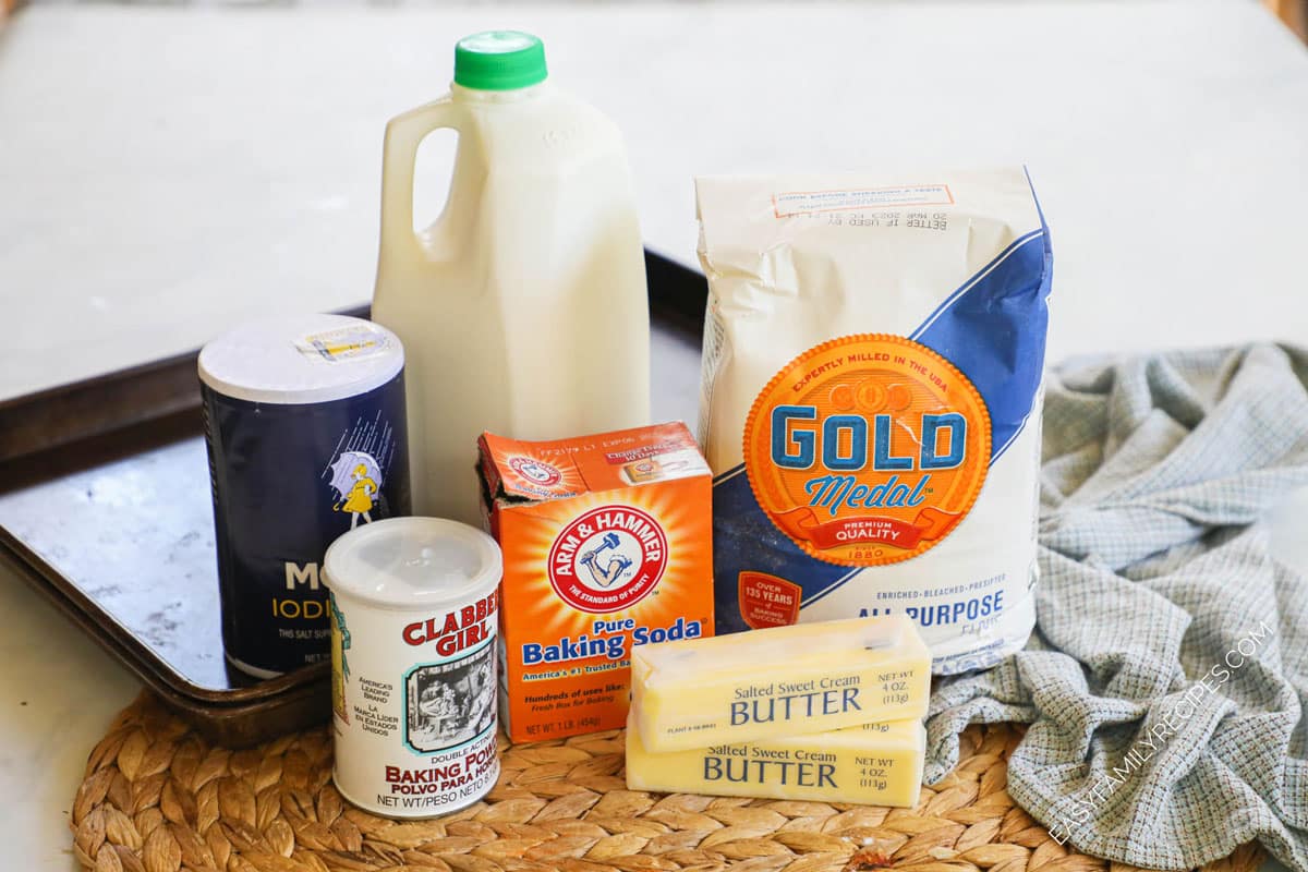 Ingredients for recipe in original packaging: salt, baking powder, a half gallon jug of buttermilk, box of baking soda, bag of all-purpose flour, and two sticks of butter.