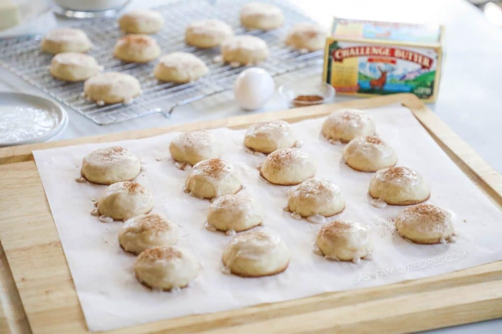 Butter cookies with cinnamon glaze on parchment paper