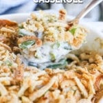 Green Bean Casserole being scooped out of a white baking dish