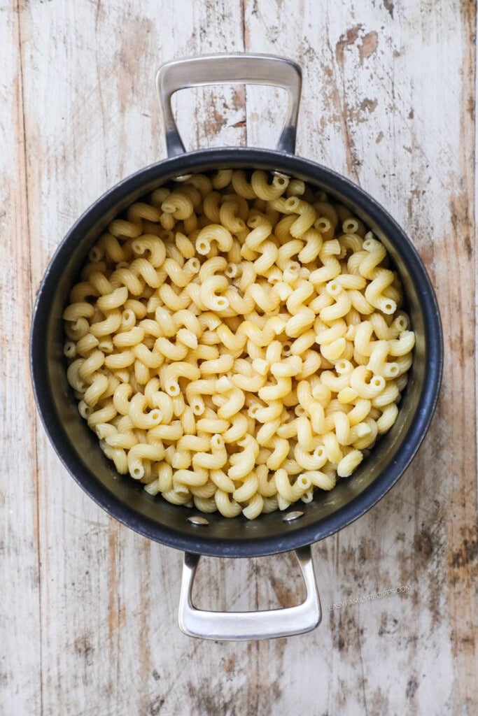 How to make Baked Mac and Cheese Step 1: Boil the macaroni then drain water and return to pan.