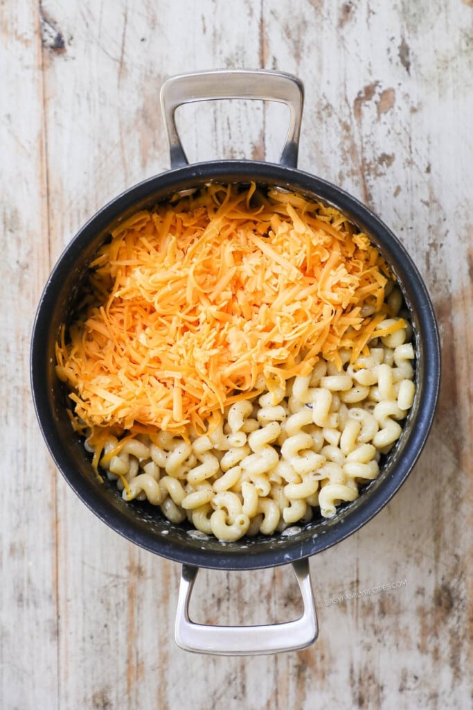 How to make Baked Mac and Cheese Step 2: Add butter, cheese, milk, salt, pepper, and egg.