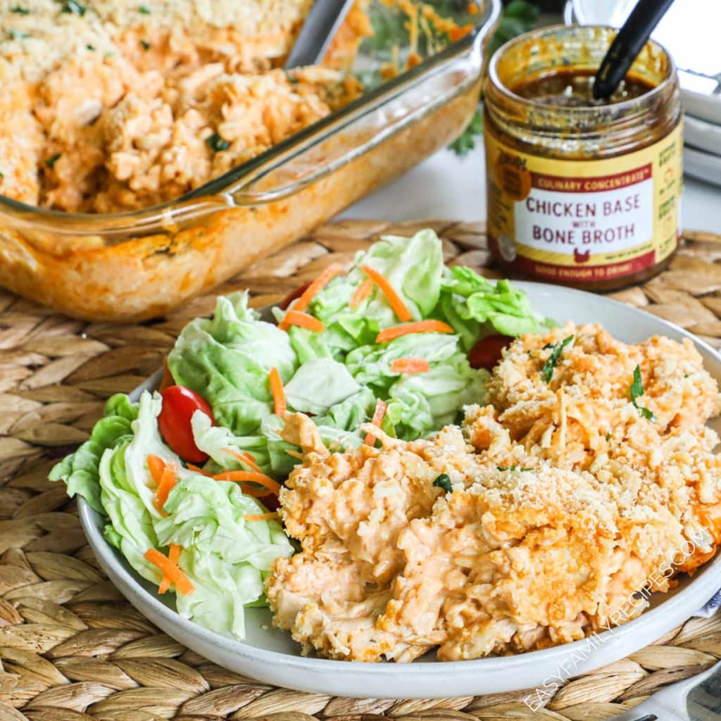 Buffalo Chicken rice casserole with salad on a plate