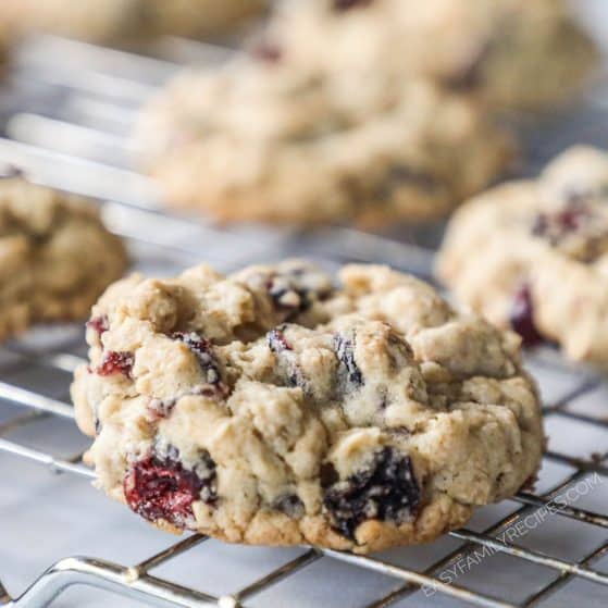 Cranberry oatmeal cookies baked on a cooling rack,