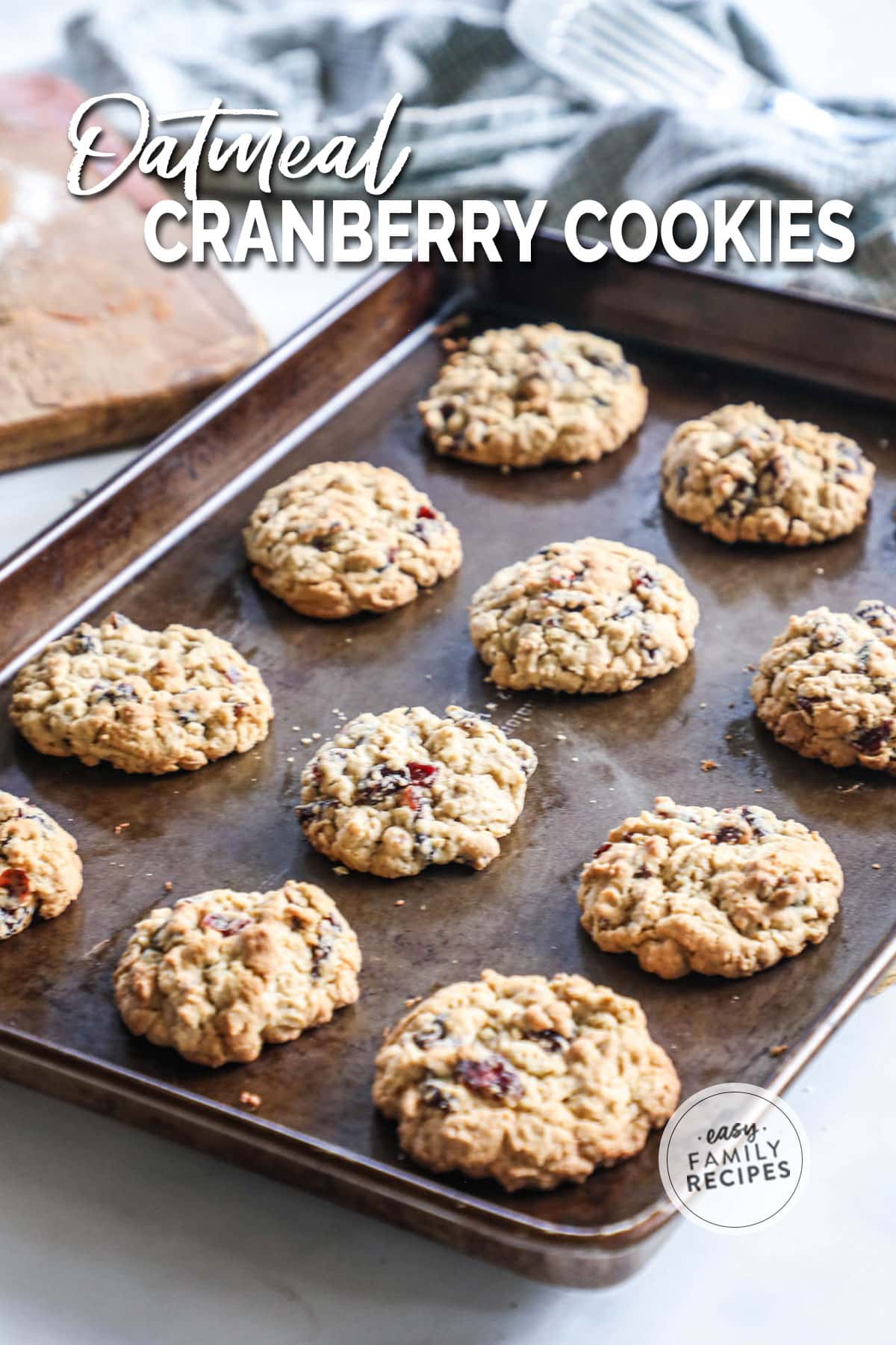 Cranberry oatmeal cookies on a baking tray after being baked.
