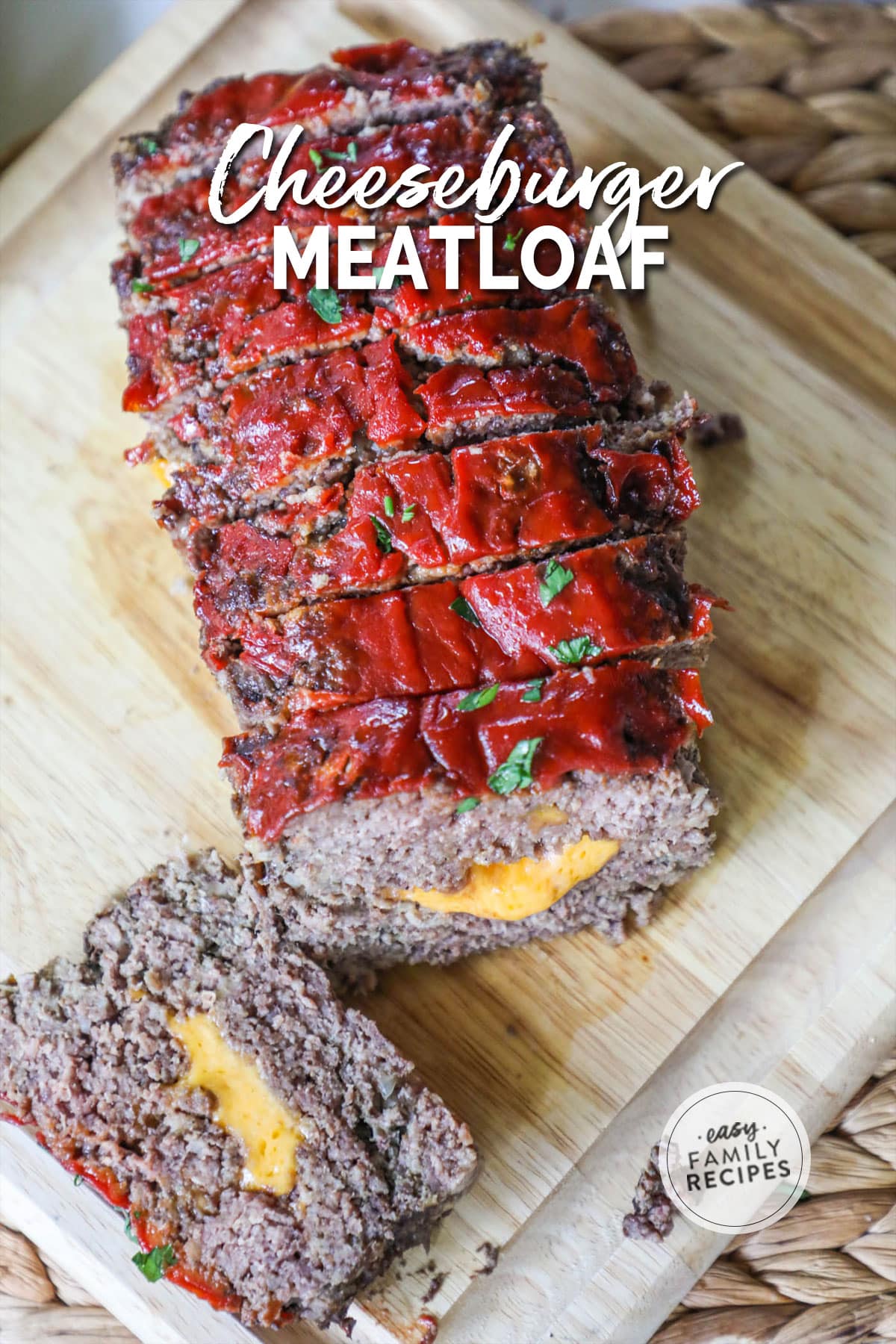 a cheddar cheese stuffed meatloaf baked and sliced on a cutting board.