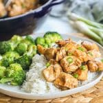 A plate with white rice, broccoli, and teriyaki chicken bites.