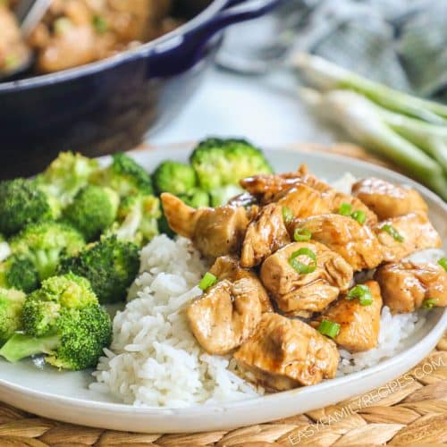 A plate with white rice, broccoli, and teriyaki chicken bites.
