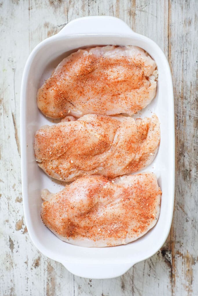 Step 3 of Baked Chicken Breast recipe - coat chicken breasts with seasoning