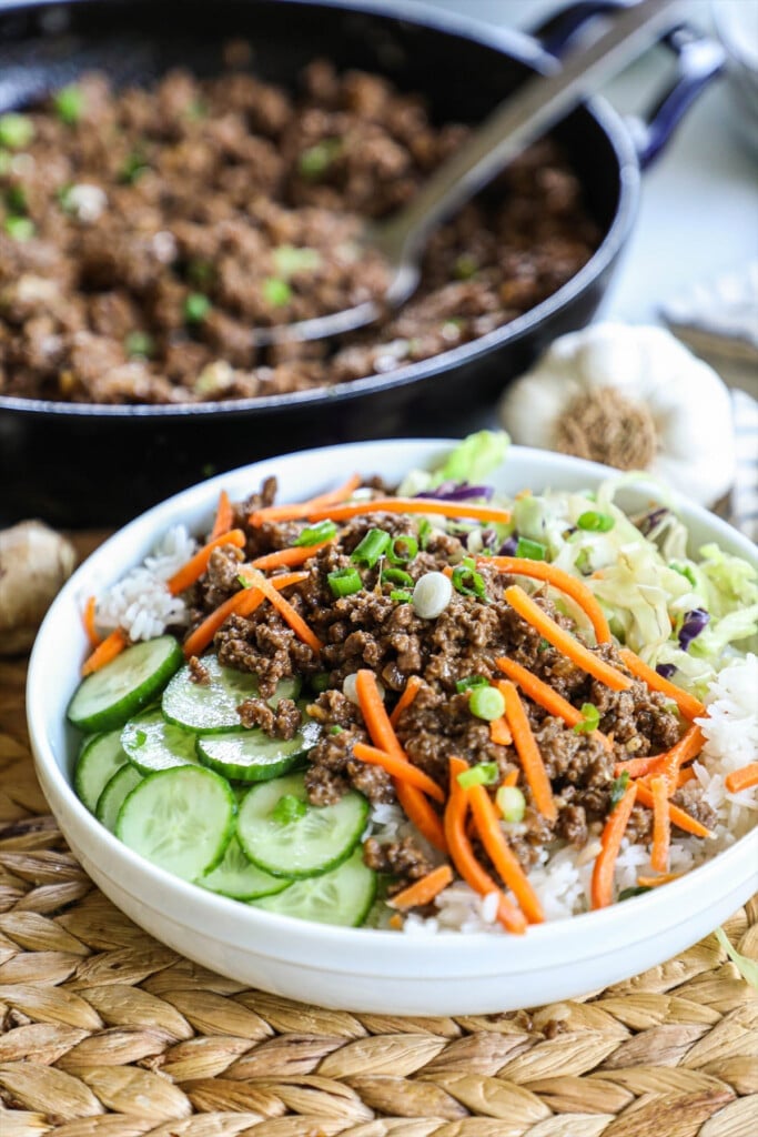 How to make Korean Beef Bowl Step 4: Assemble the Korean Beef Bowl by combining rice, Korean ground beef, cucumber, carrots and cabbage.