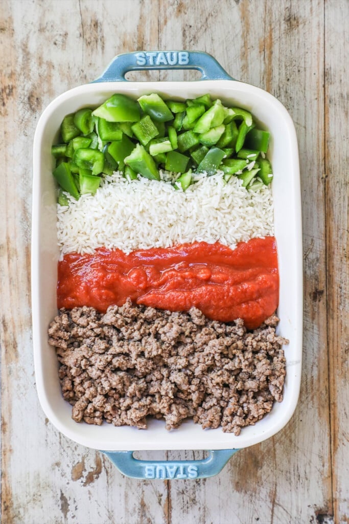 How to make stuffed pepper casserole step 1: combine the ground beef, tomato sauce, rice bell peppers, seasonings, and broth together.