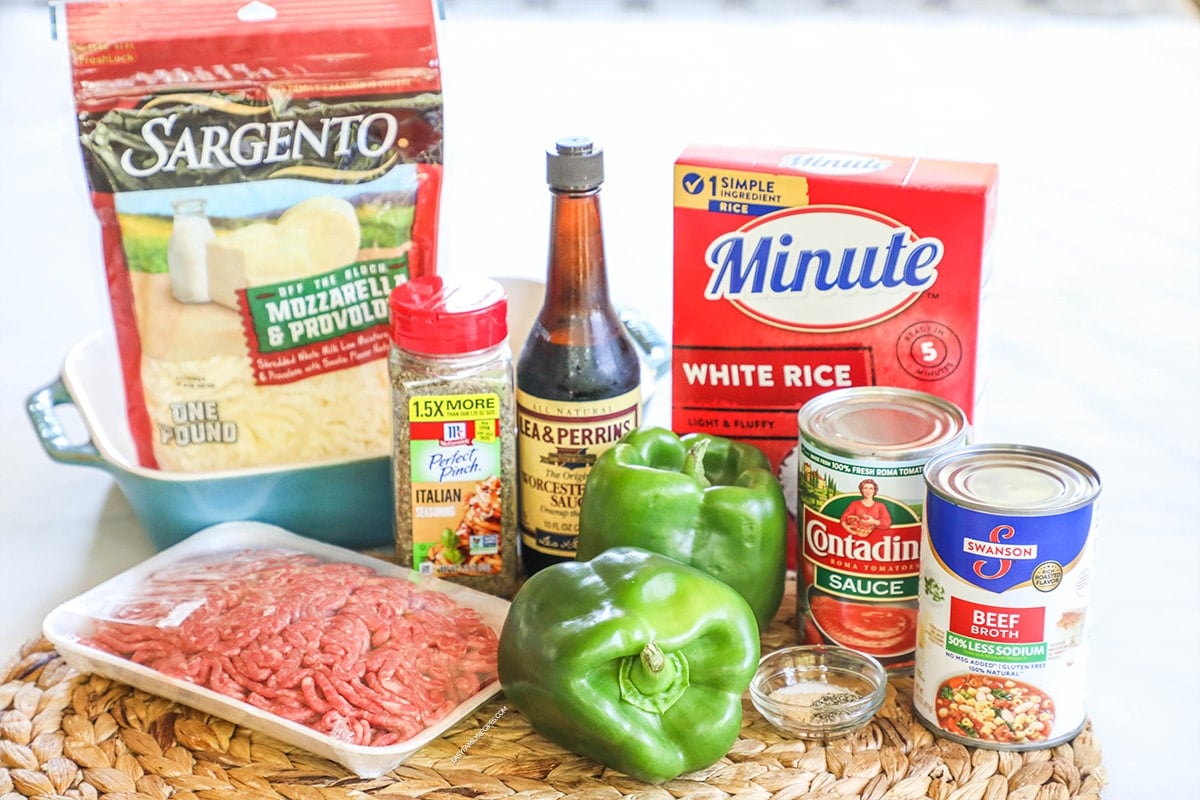 Stuffed Pepper Casserole ingredients including minute rice, ground beef, green bell peppers, tomato sauce, beef broth, seasonings, and cheese.