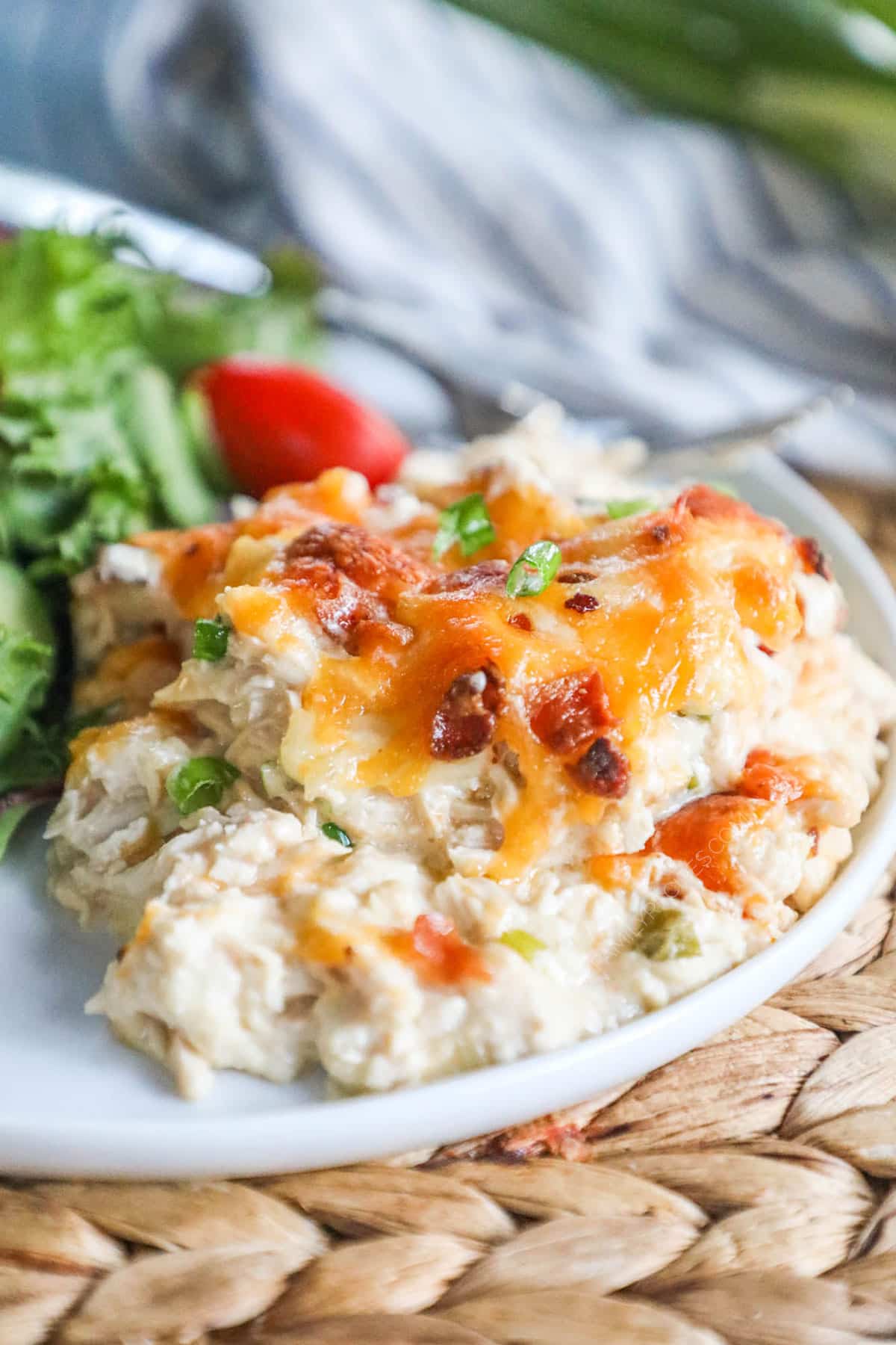 Million Dollar Chicken Casserole scooped on a plate with a side salad