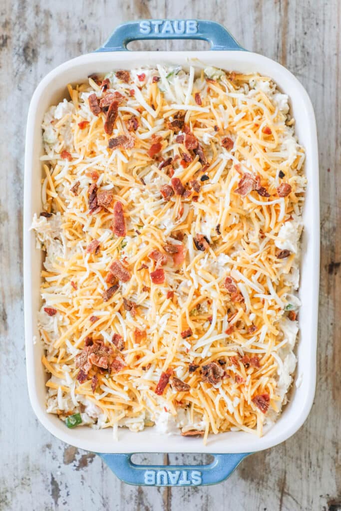 Steps to make Million Dollar Chicken Casserole Step 3: Transfer to 2 quart casserole dish. Add shredded cheese and bacon