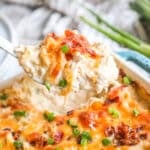 Million Dollar Chicken Casserole being scooped out of the baking dish